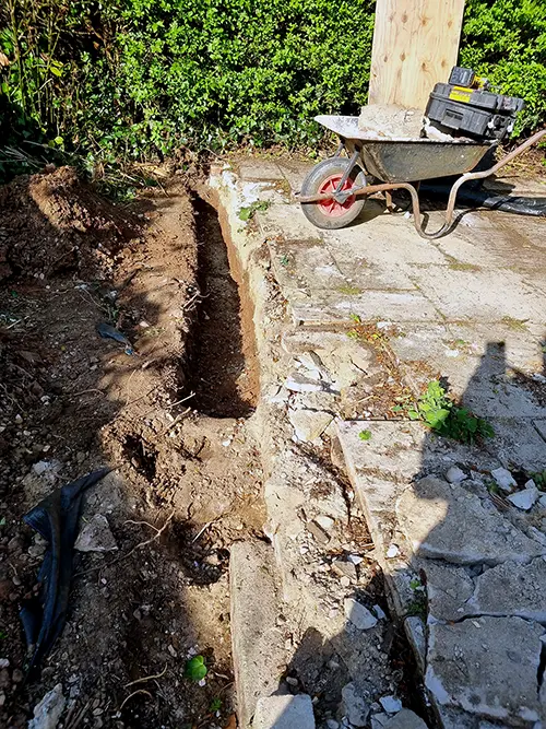 Excavating a foundation trench for the patio edge